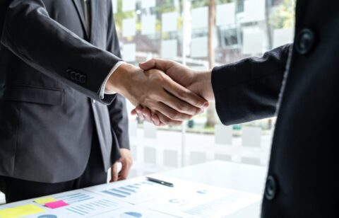 Finishing up a meeting collaboration, handshake of two business people after contract agreement to become a partner, collaborative teamwork.