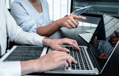 Team of Developer programmer working on coding program software computer in office, Writing website and development database technology.